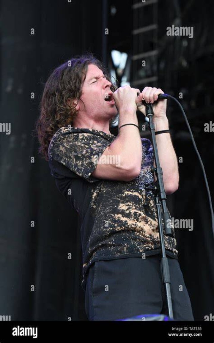 Singer Brendan Yates is shown performing on stage during a "live" stand